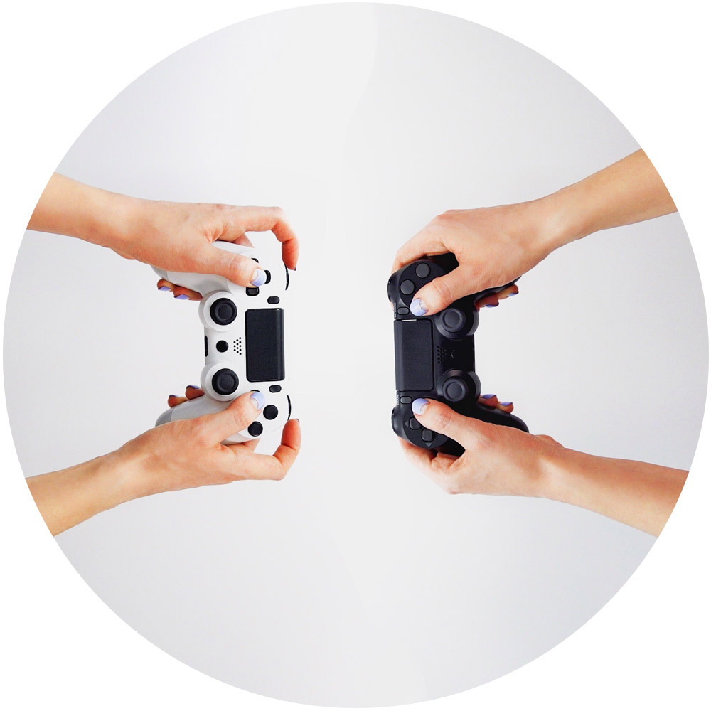 Zwei Paar Hände, die Videospiel-Controller halten, stehen sich vor einem weißen Hintergrund gegenüber und verkörpern Gamification. Das linke Paar hält einen weißen Controller, während das rechte einen schwarzen hält, was einen interaktiven Gaming-Wettbewerb suggeriert.